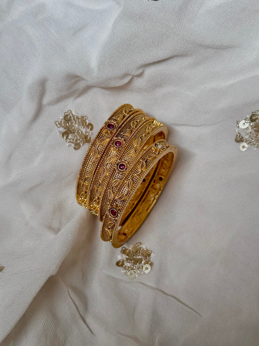 Floral craftings on yellow gold bangles